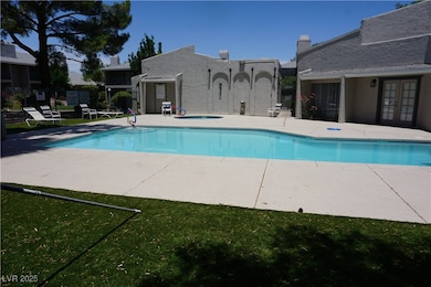 Community pool with french doors, a patio, and a h
