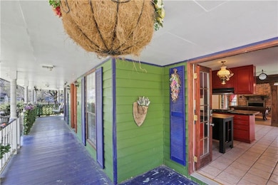 Vibrant porch has swing on other end. Double door 