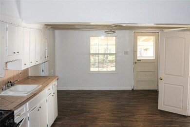 Kitchen featuring tile countertops, dark wood-type