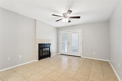 Living room with fireplace and French doors to pat