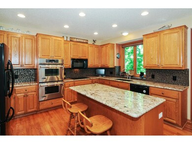A center island in the kitchen has a breakfast bar