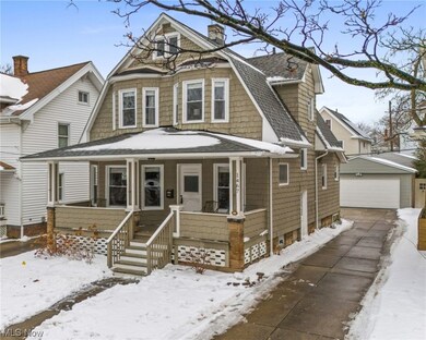 Victorian-style house with a garage and a porch