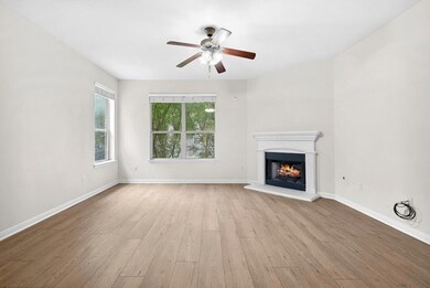 Unfurnished living room with wood finished floors