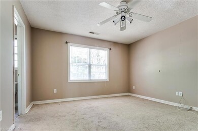 Master bedroom with peaceful wooded views.
