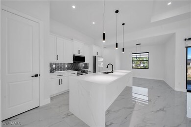 Kitchen featuring a sink, marble finish floor, sta