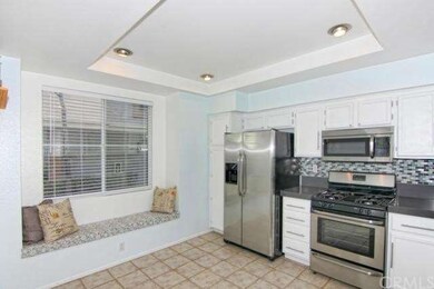 Glass tile backsplash and cozy window seat.
