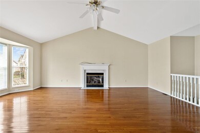 Sunny living room with fireplace, hardwood floors,