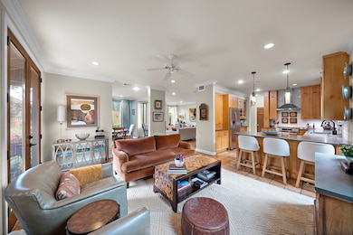 Inviting Den opens to the Kitchen.