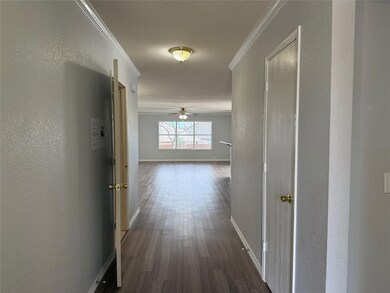 Hallway featuring crown molding and dark wood-type flooring