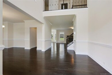 Airy 2 story foyer. Notice the wide plank hardwood