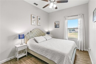 Bedroom featuring wood-type flooring and ceiling fan