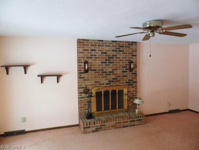 Family room fireplace and ceiling fan.