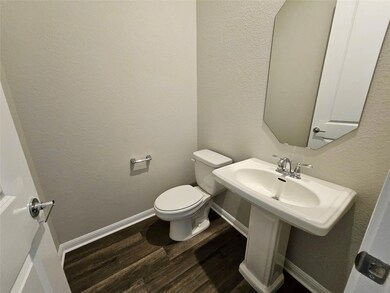 Bathroom with baseboards, toilet, and wood finish