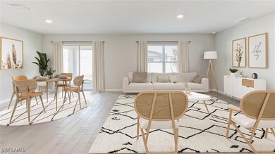 Living area featuring baseboards, light wood finis