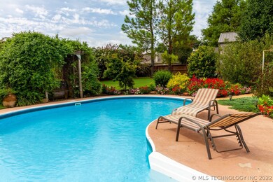 Enticing in-ground pool with trampoline cover.