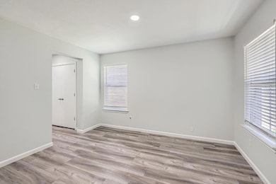Spare room with light wood-style floors and reces