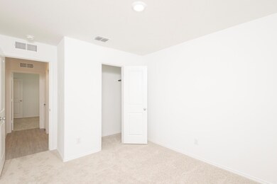 Unfurnished bedroom featuring light colored carpet