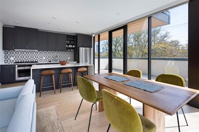 Dining room with a wall of windows and light wood