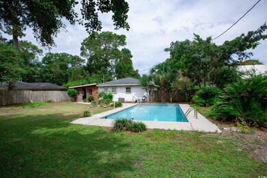 View of swimming pool featuring a yard