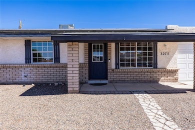Property entrance with brick siding, a porch, sola
