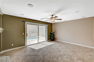Empty room featuring a ceiling fan, light tile pat