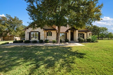 View of front of home featuring stone siding and a front lawn