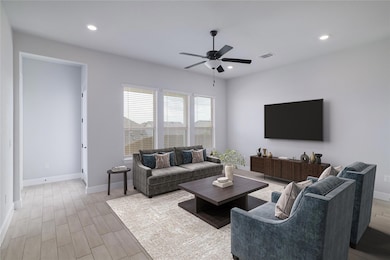 Living room featuring ceiling fan, recessed light