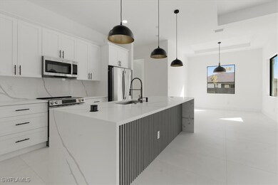 Kitchen featuring pendant lighting, appliances wit