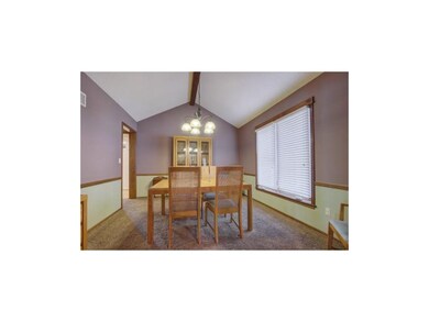 Dramatic formal dining room with vaulted ceiling i