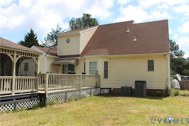 Back of property with a deck, a yard, crawl space, and a shingled roof