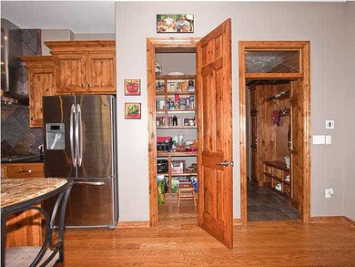 Large walk-in kitchen pantry and view of slate flo
