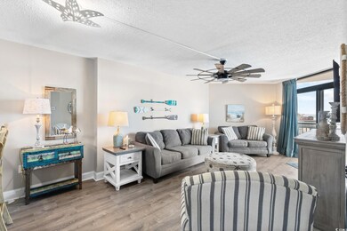 Living area featuring baseboards, a textured ceili