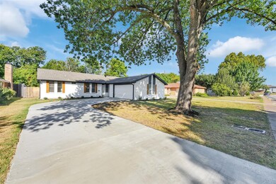 Ranch-style home with a garage and a front yard