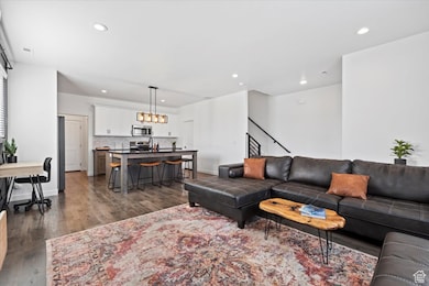 Living room featuring dark wood-style flooring and recessed lighting