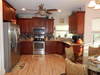 The kitchen has lots of cabinets, SS appliances and granite countertops
