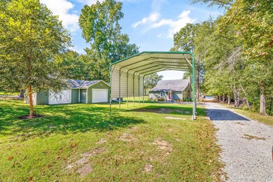 View of yard with an outbuilding and a carport