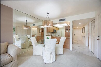 Tiled dining area with a chandelier
