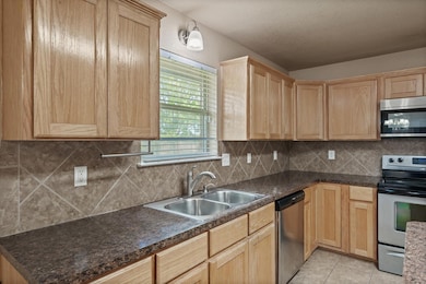 Kitchen featuring appliances with stainless steel