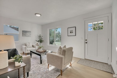 Living area featuring light wood finished floors and baseboards