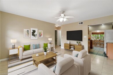 Living room featuring visible vents, baseboards, c
