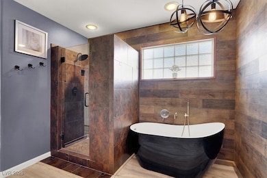 Bathroom with a notable chandelier, wood finished