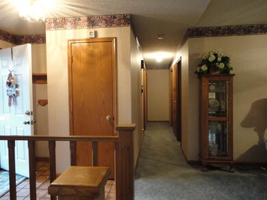 Foyer area with tile, hall closet and view of hall