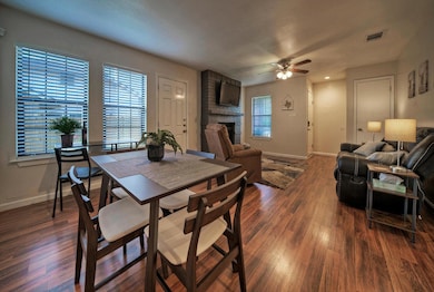 Dining room featuring a brick fireplace, ceiling 