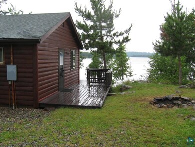 deck with water view and a lawn