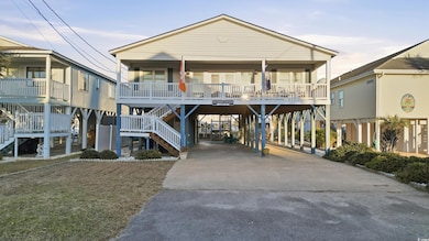 View of front of property with a carport, driveway, stairs, a porch, and a front lawn