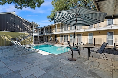 Community pool featuring a patio and stairs