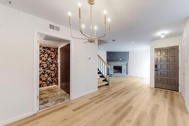 Unfurnished living room featuring light wood-style