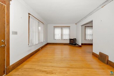 Unfurnished room with light hardwood / wood-style 