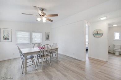 Dining room featuring ceiling fan and light wood-t