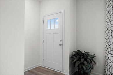 Entryway with wood finished floors and baseboards